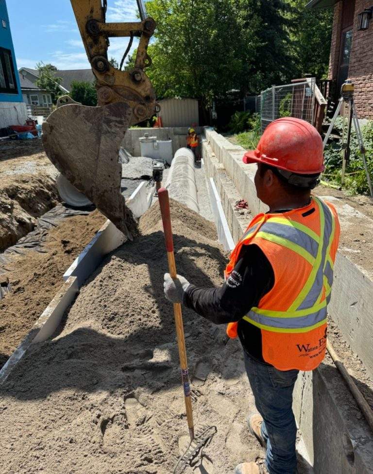 Excavator and a worker on-site with excavation contractors