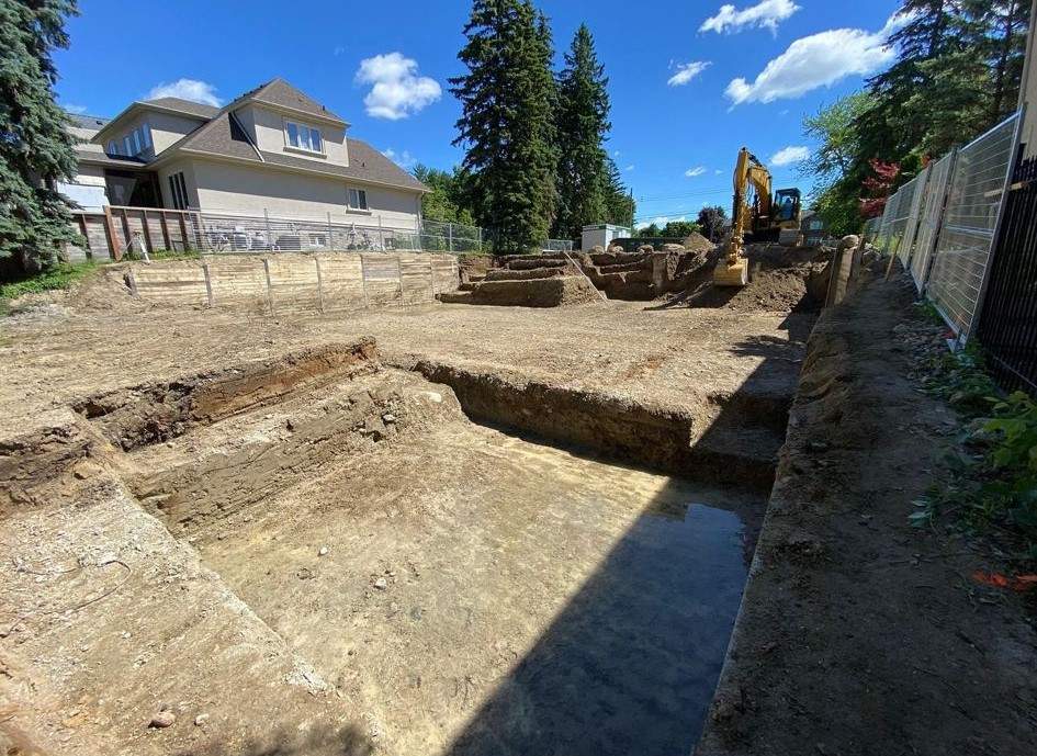 Wallace Excavation team performing commercial and residential excavation services, using advanced machinery to remove soil for footings, basements, and underground utilities.